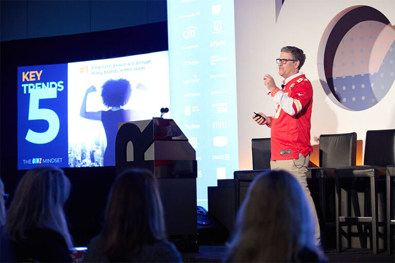 Man in chiefs jersey speaking on stage