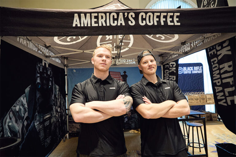 Two people under America's Coffee tent