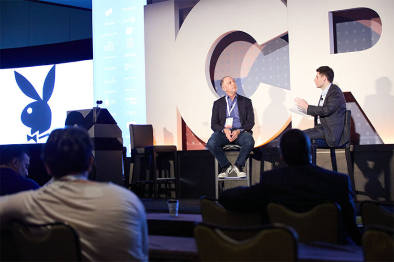 Two men speaking on stage