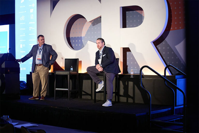 Two men speaking on stage